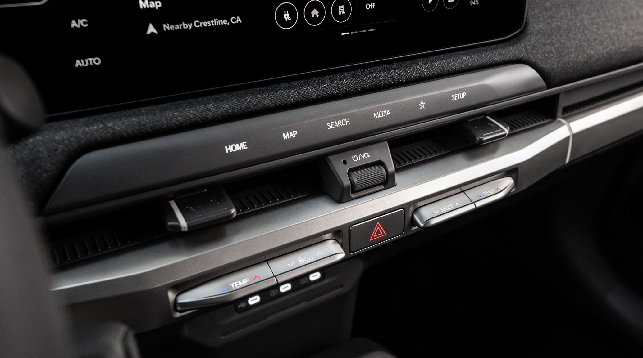 Close-up image of a center panel inside the 2027 Kia EV3 compact electric SUV showcasing the dual-zone auto climate control options.