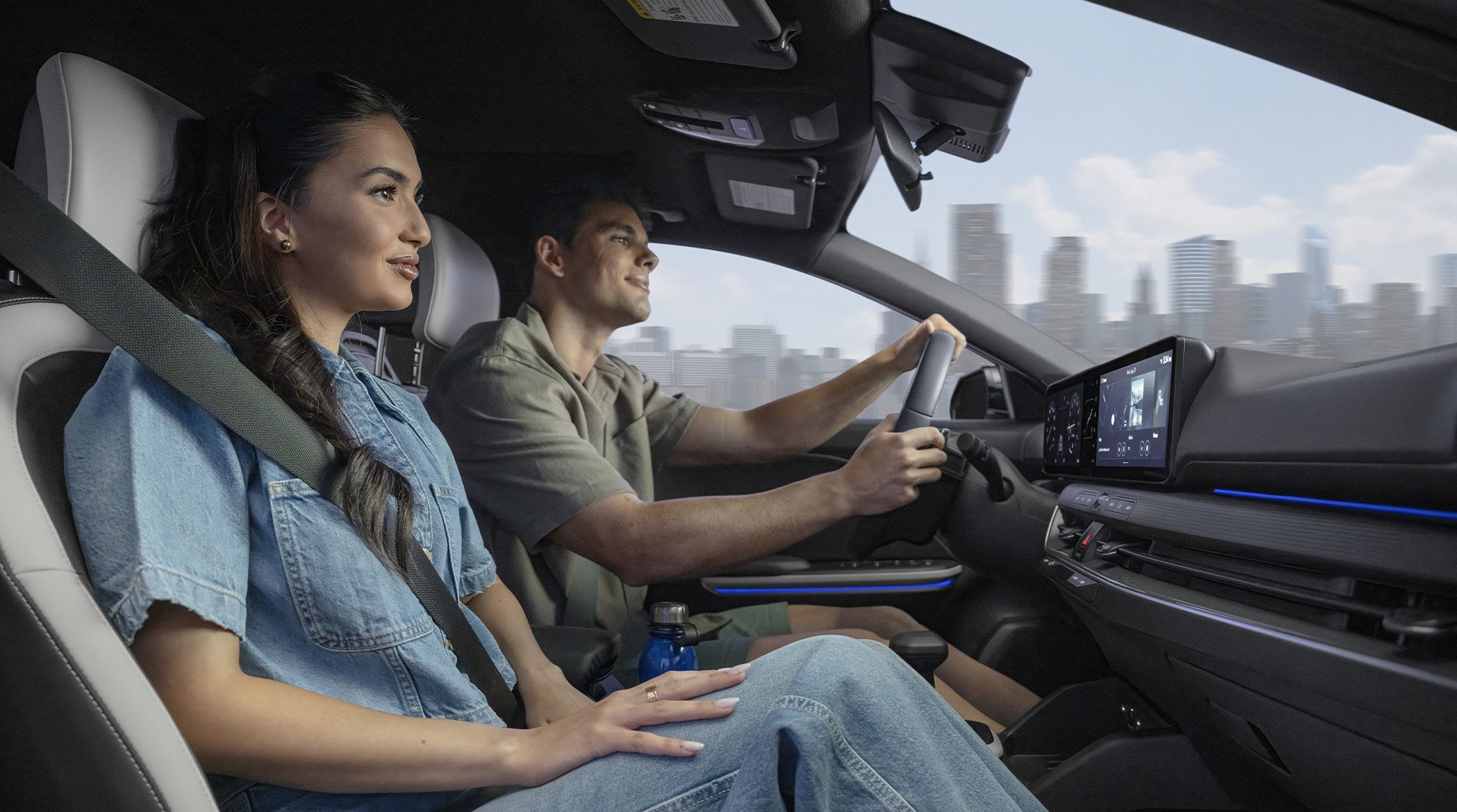 An interior shot from the passenger's view of the 2026 K4 Hatchback GT-Line Turbo featuring black and white SynTex seat trim with a driver seated behind the wheel.