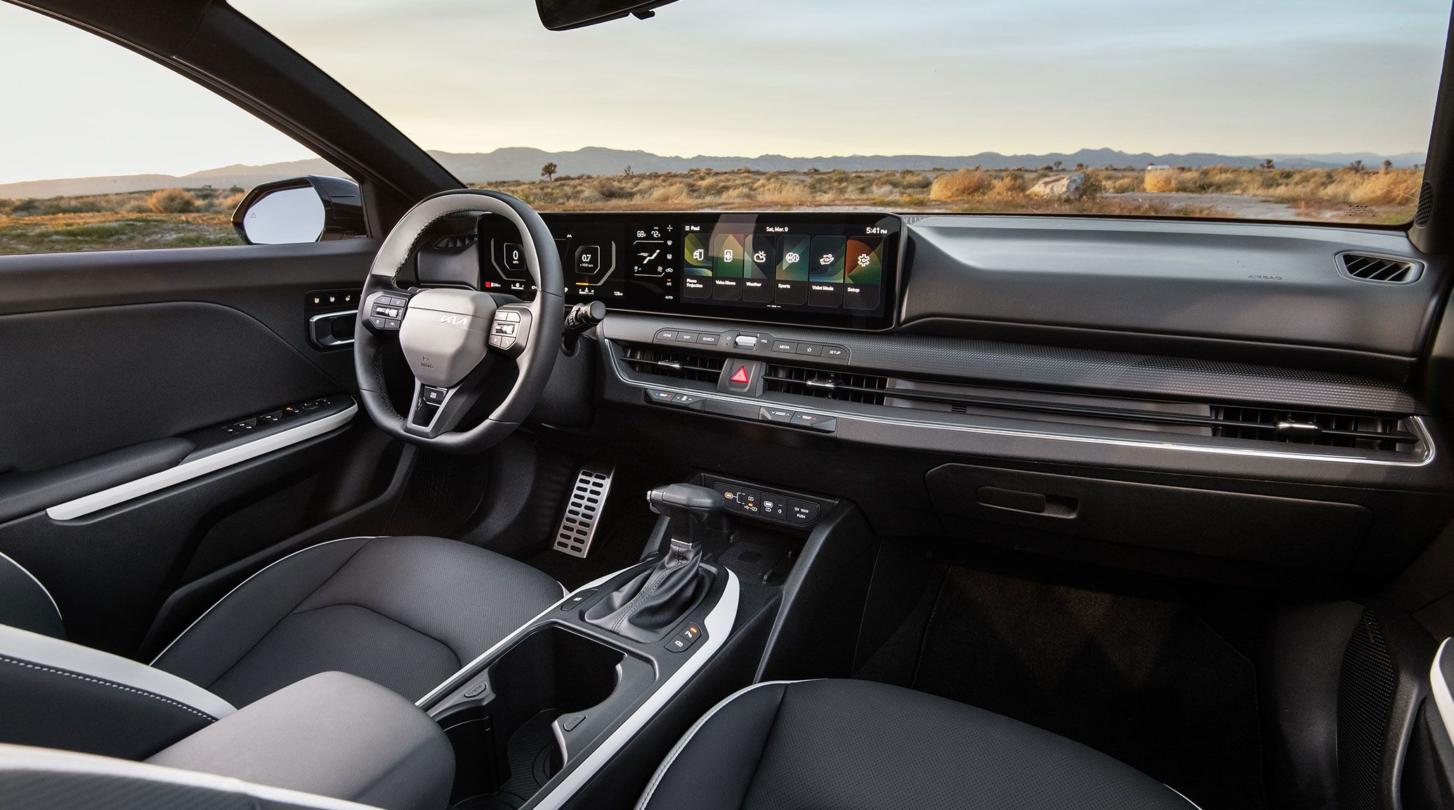 Interior of the 2026 Kia K4 sedan, including steering wheel and nearly 30 inches of digital instrumentation