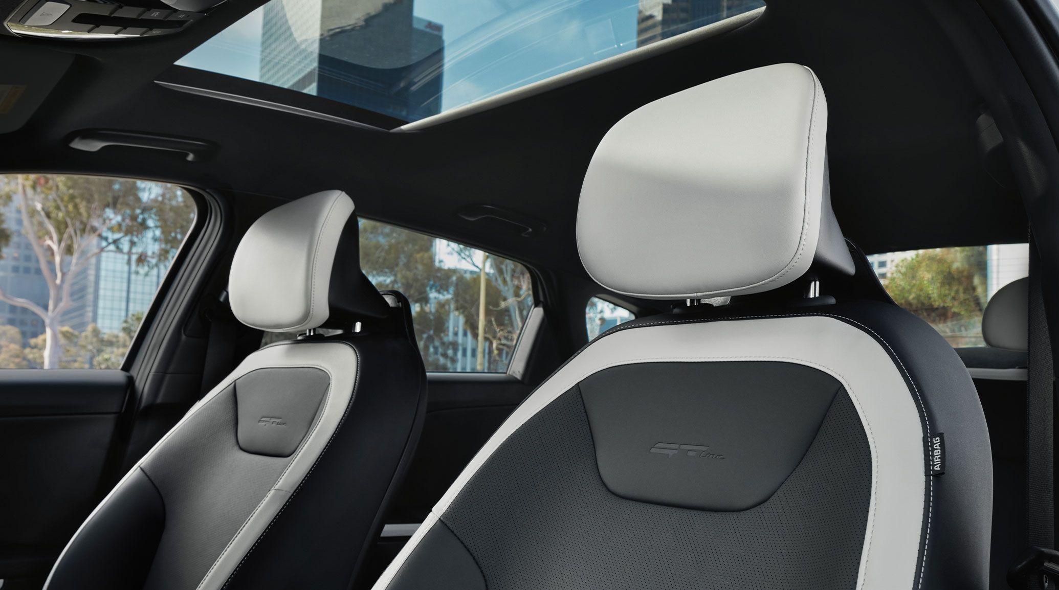 Interior view of the 2026 Kia K4 sedan's black and white SynTex seat trims, including heating and ventilation options