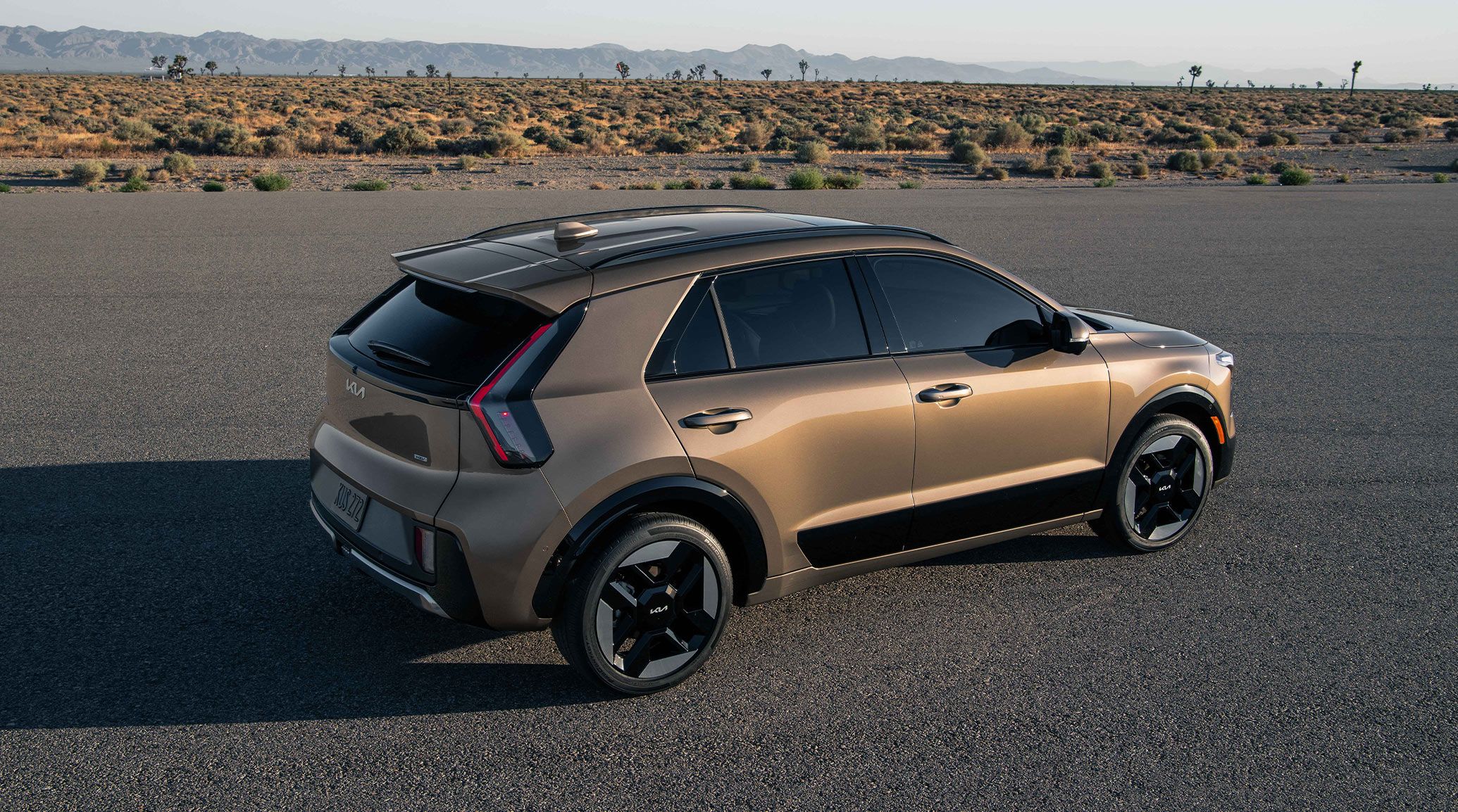 High-angle photograph of the 2027 Kia Niro HEV SUV with visible roof rails, also showcasing its stylish exterior and angles.