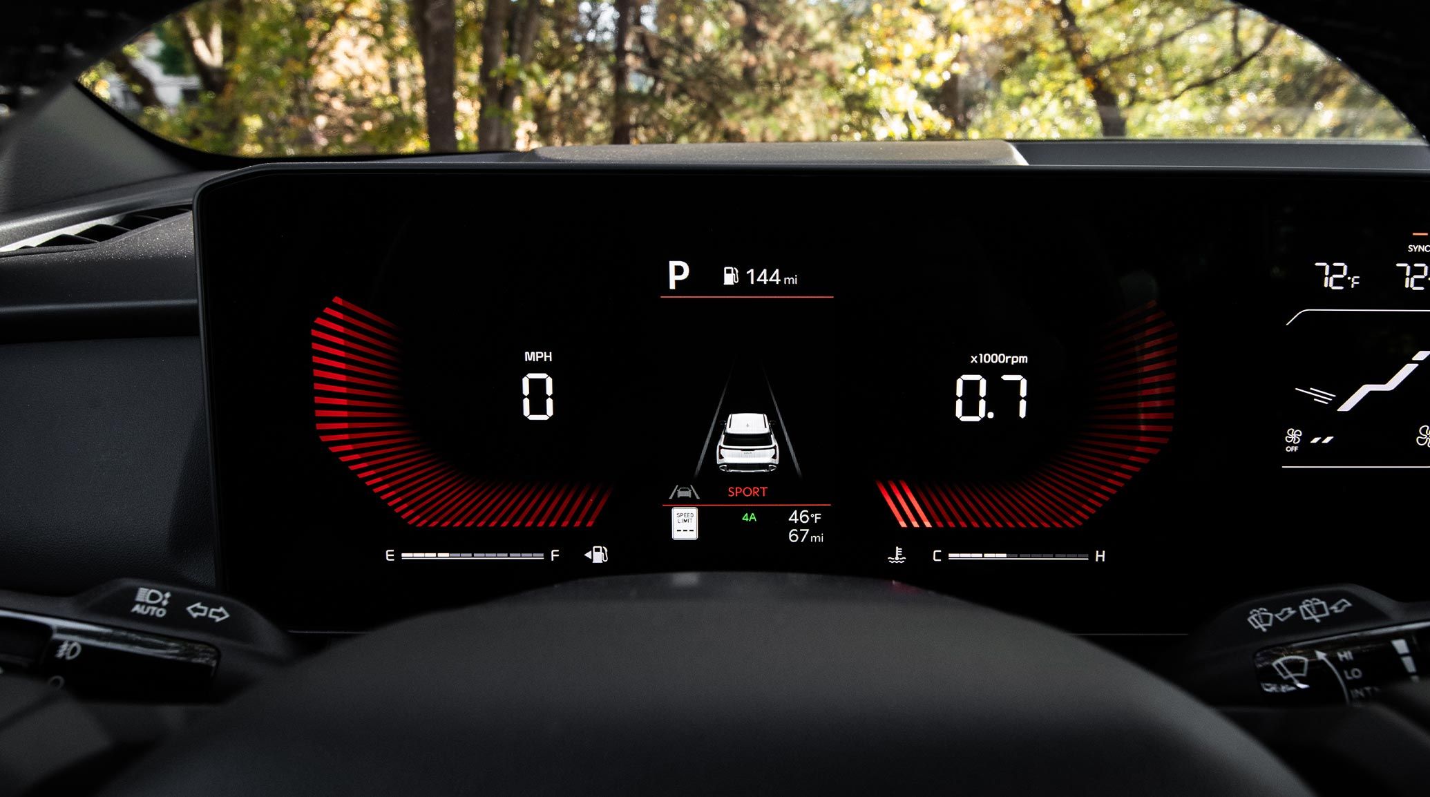 Zoomed in view of the digital instrument cluster on the 2027 Kia Seltos that features 0 MPH on the left, the vehicle image in a lane in the middle, saying it is in sport mode under, and climate controls besides it.