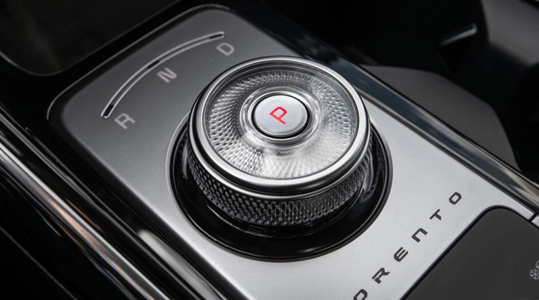 Interior close-up view of the 2027 Kia Sorento Hybrid SUV's rotary shifter dial with R N D and P symbols visible.