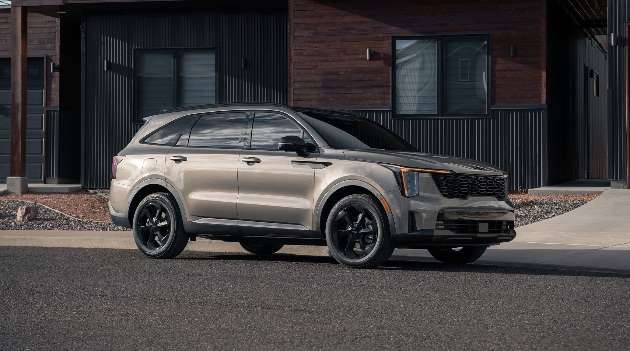 2026 Kia Sorento Plug-In Hybrid in brown, three-quarter front view, parked in front of  a residence