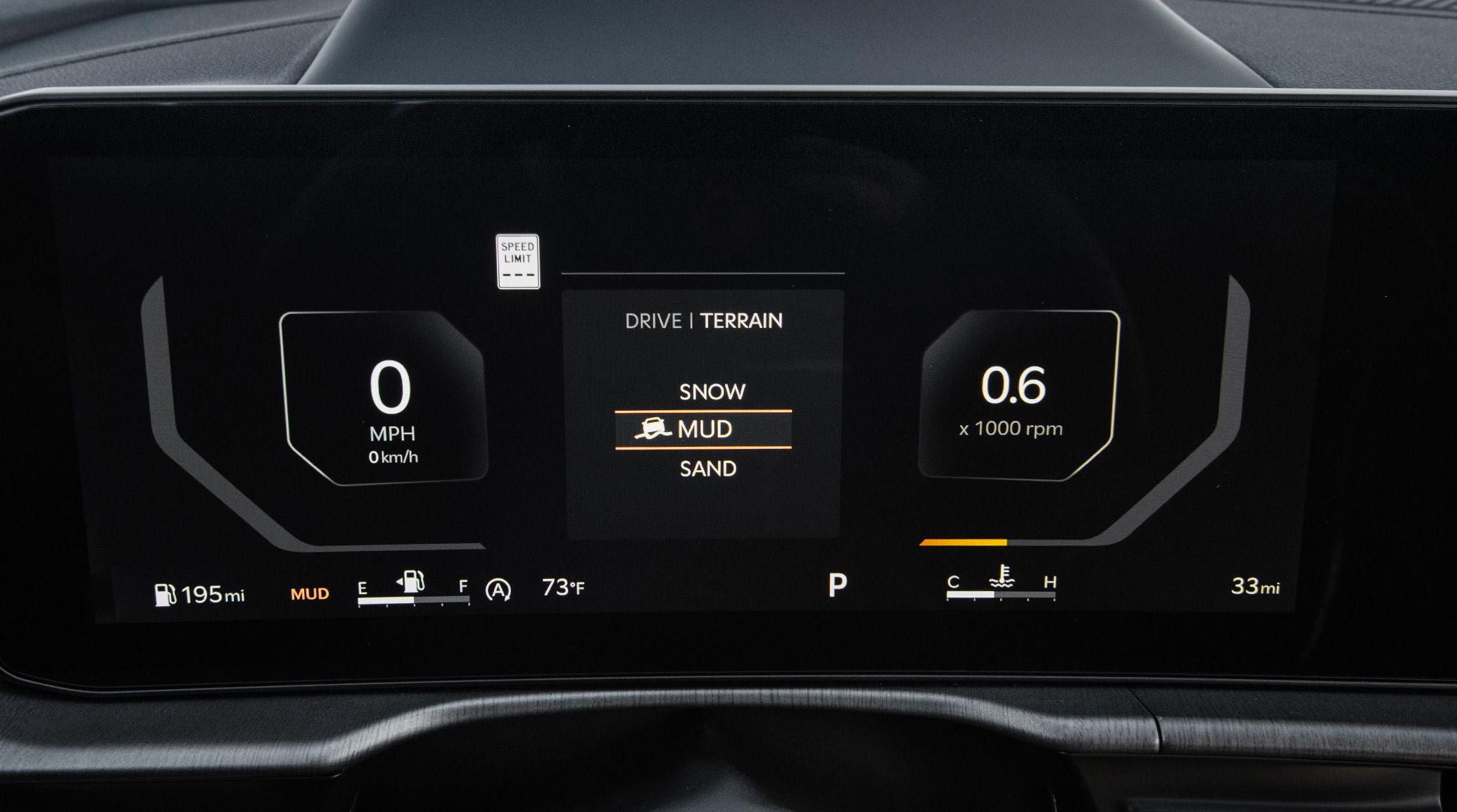 Close-up photograph of the digital display inside the 2027 Kia Sportage SUV, showing 0 MPH speed, 195 miles for gas, the fuel meter, temperature, speed limit, RPM, and terrain mode settings, such as Snow, Mud, and Sand.