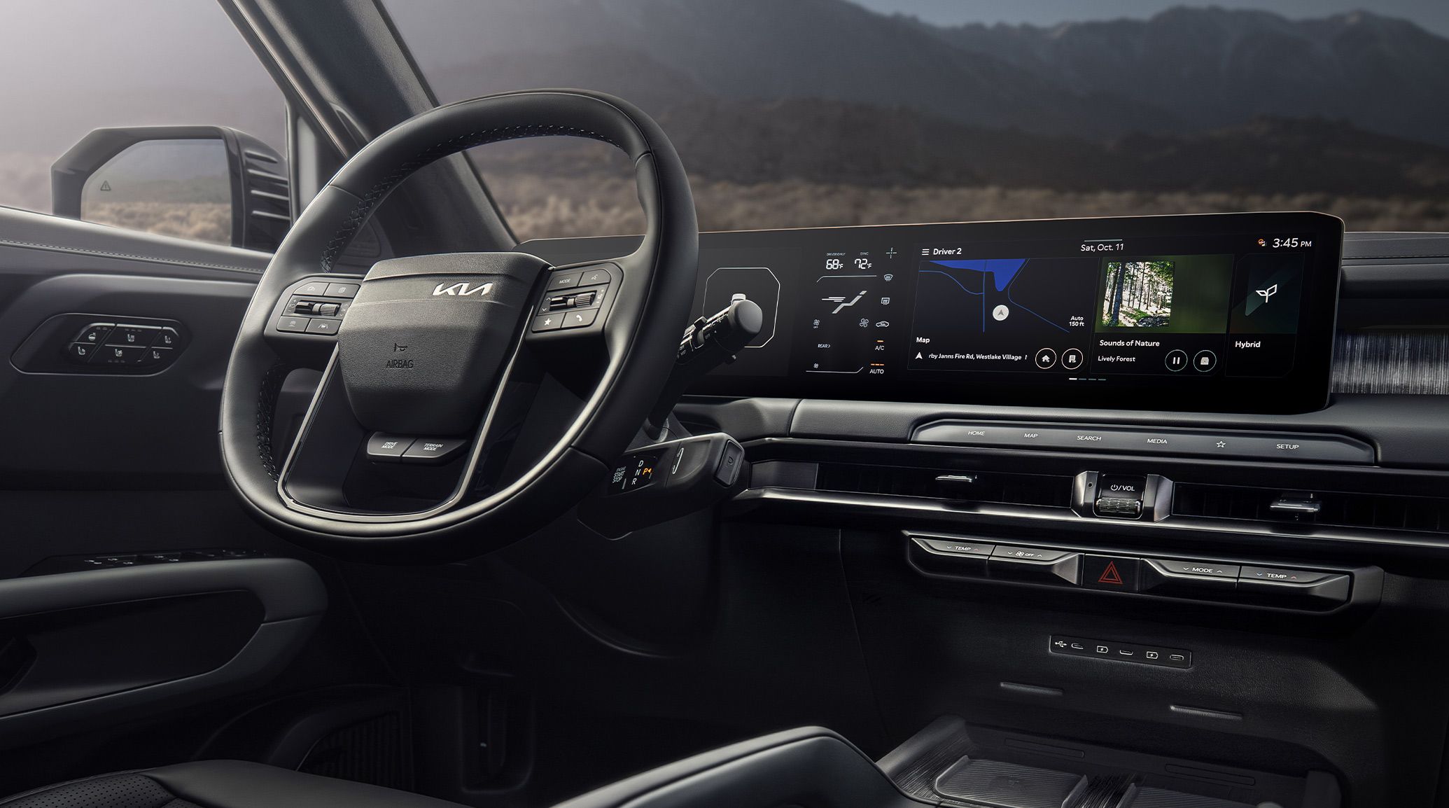 The interior of the 2027 Kia Telluride Hybrid featuring the modern steering wheel and a high-tech dashboard display with navigation and media controls, with blurred mountain and forest views visible through the windows.