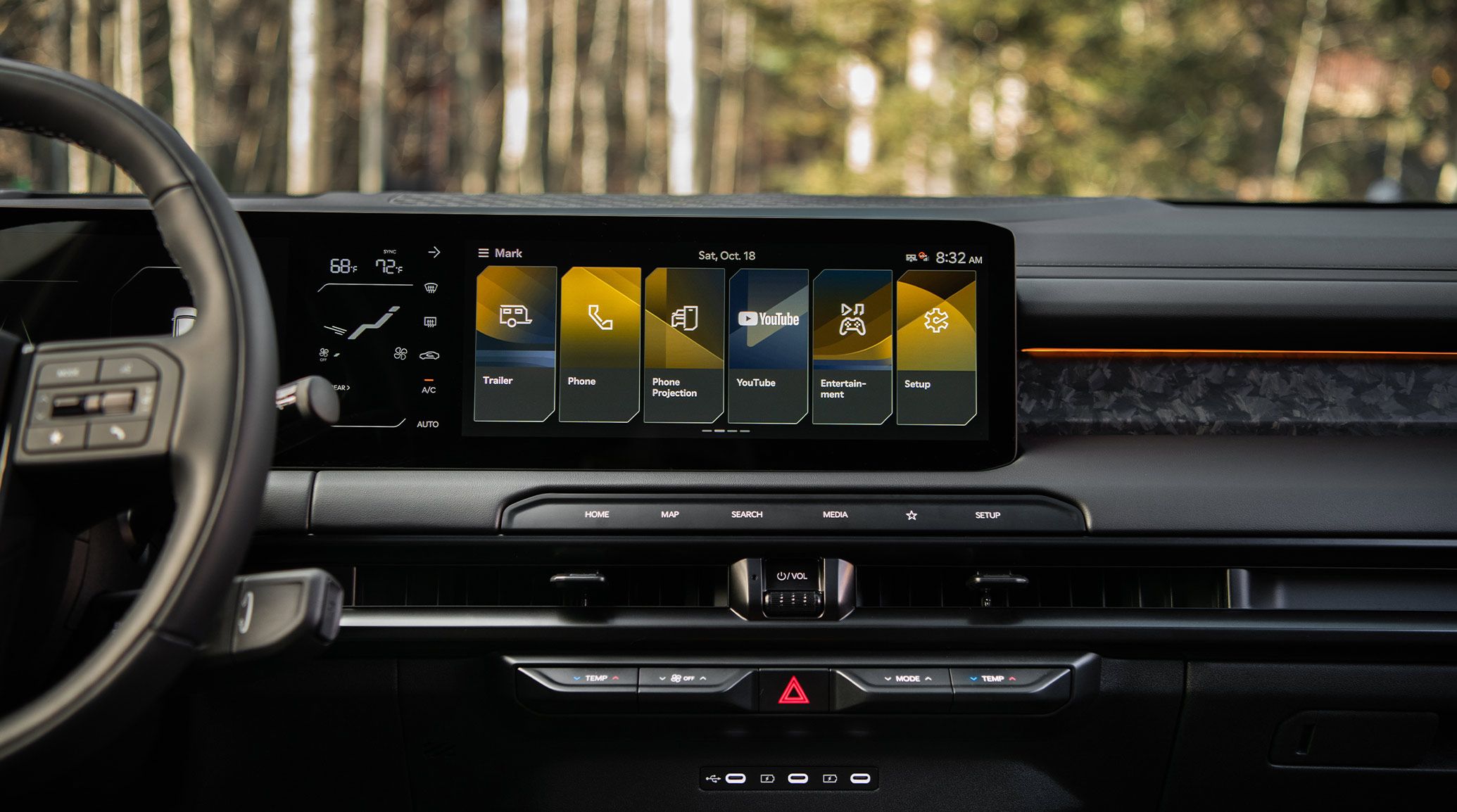 Close-up interior shot of 2027 Kia Telluride with a premium black cabin, featuring a large touchscreen digital display and modern dashboard, with a glimpse of a tree visible through the windshield.