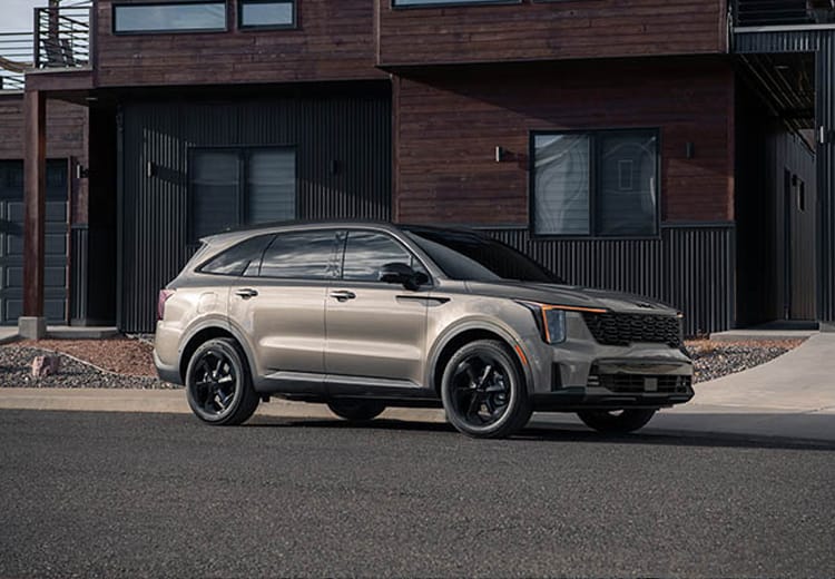2026 Kia Sorento Plug-In Hybrid in brown, three-quarter front view, parked in front of  a residence